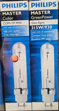 Two Philips Master Color and Philips Master GreenPower commercial light bulb boxes on a store shelf. The left box reads 'Philips Master Color CDM-TP MW' and the right box reads 'Philips Master GreenPower Elite Agro 315W/930'.