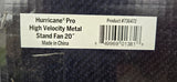 A close-up of a white product label on a dark textured item. The label reads 'Hurricane Pro High Velocity Metal Stand Fan 20" Made in China' with a barcode and product number 'Product #736472'.