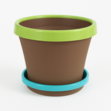 Brown planter with green rim and blue base on a white background