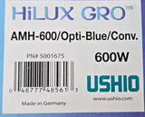 A close-up of a product box for a Ushio Hilux Gro 600W AMH-600/Opt:Blue/Conv. The box is white with blue and purple borders and features a barcode and product text.